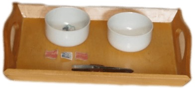 TRANSFERING STAMPS USING TWEEZERS(FEW STAMPS,TWO WOODEN BOWLS,A WOODEN TRAY WITH A PAIR OF TWEEZERS)